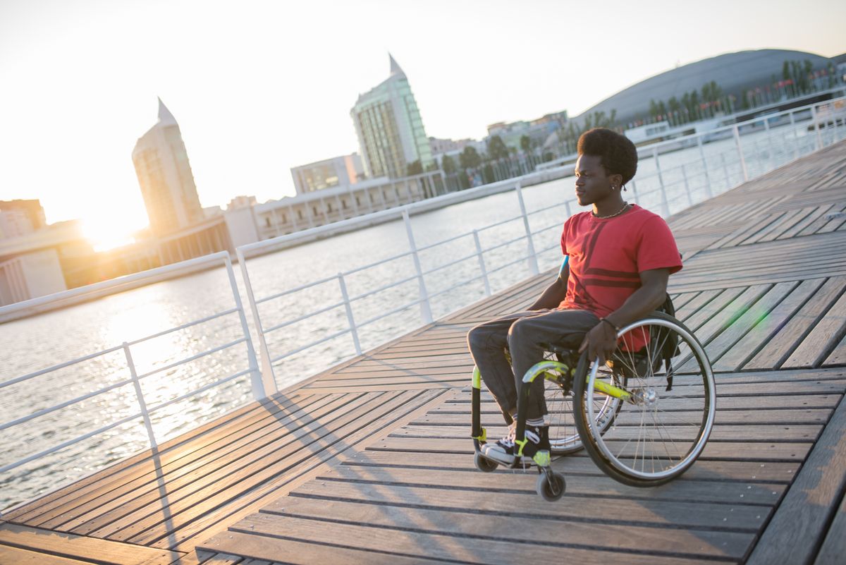 Wheelchair user enjoying a European city waterfront